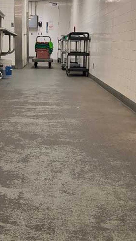 Restaurant commercial kitchen floors needing cleaning with rolling stand against wall in Ohio